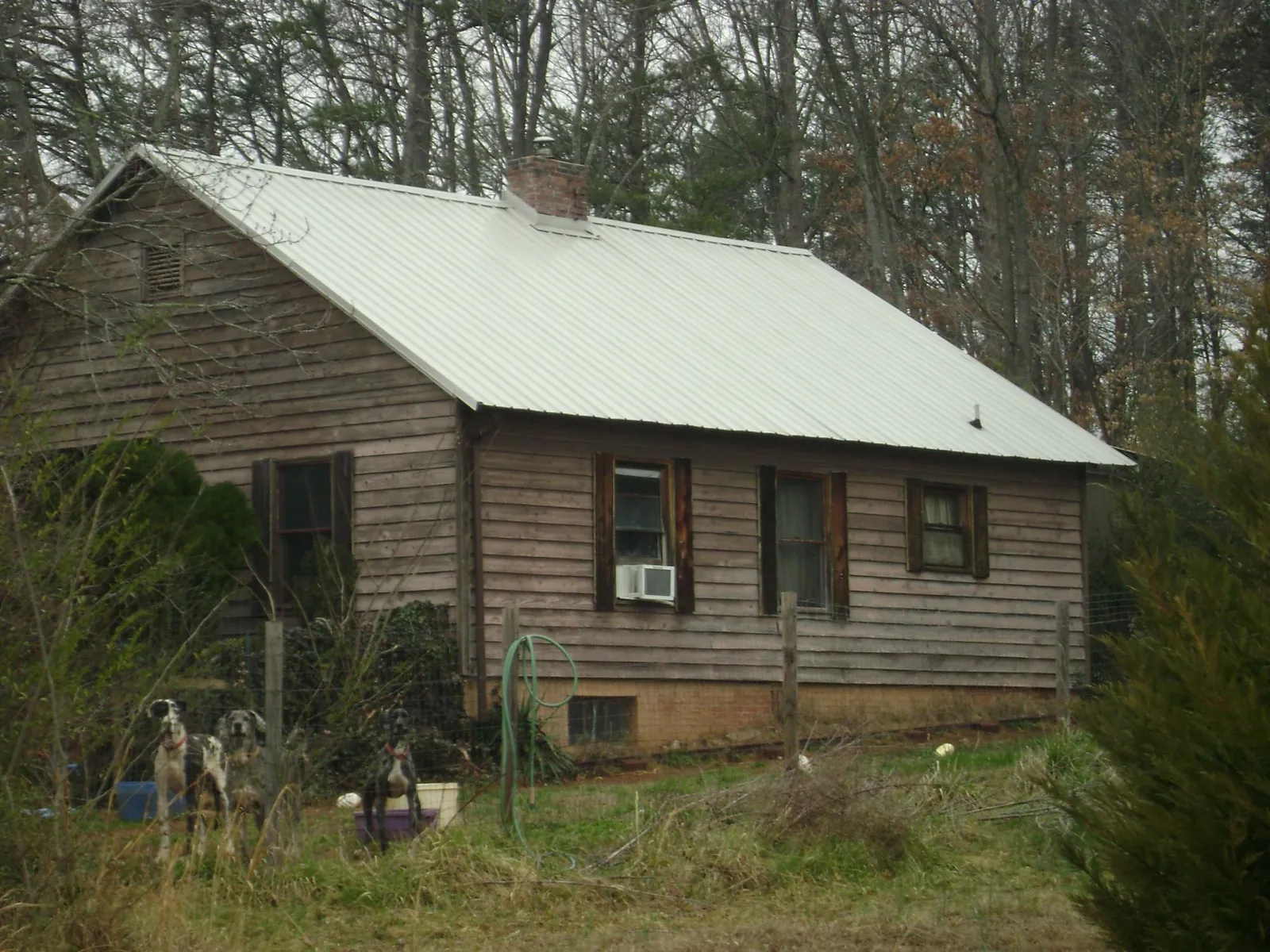 White metal roof on an old wood sided farmhouse, from a Metal Roof Installation job in Norwalk